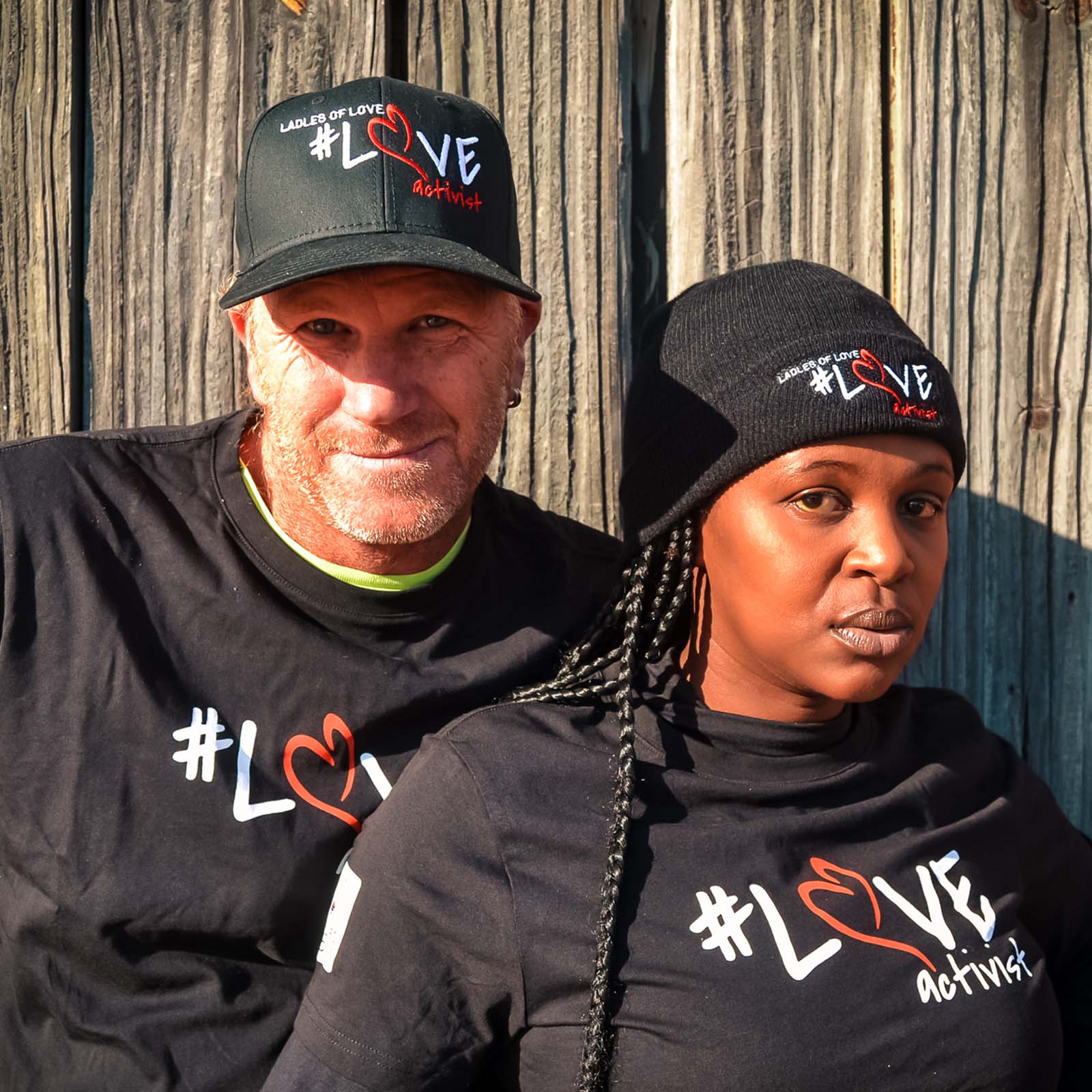 Group of south african people smiling, making heart shapes and standing with ladles of love branded clothing for the new online store where you can shop for charity