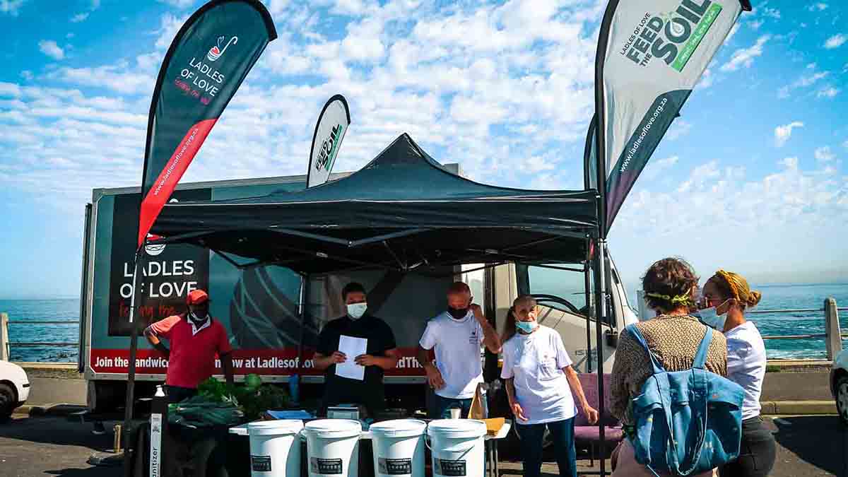 the ladles of love team set up in sea point beach in cape town for the feed the soil programme to promote sustainable farming charities in cape town